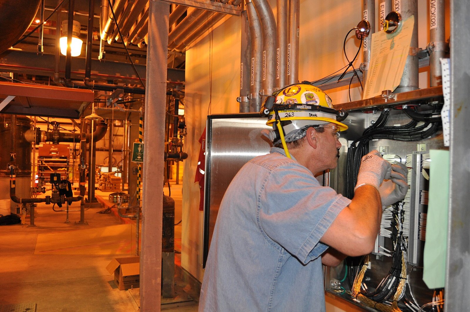 Electrician working on industrial electrical equipment