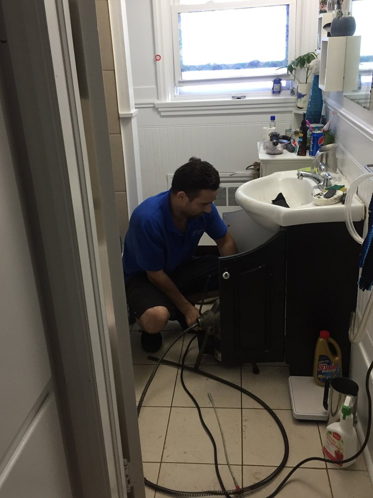 Plumber repairing a bathroom sink
